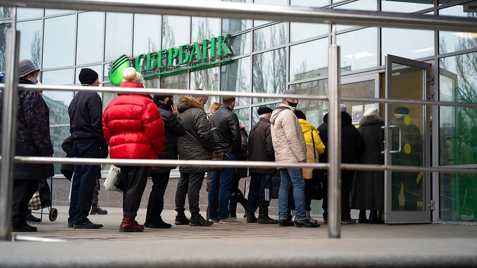 People stand in line to enter Sberbank in Moscow, Russia