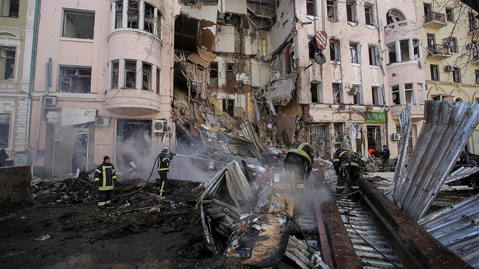 Firefighters extinguish an apartment house after a Russian rocket attack in Kharkiv