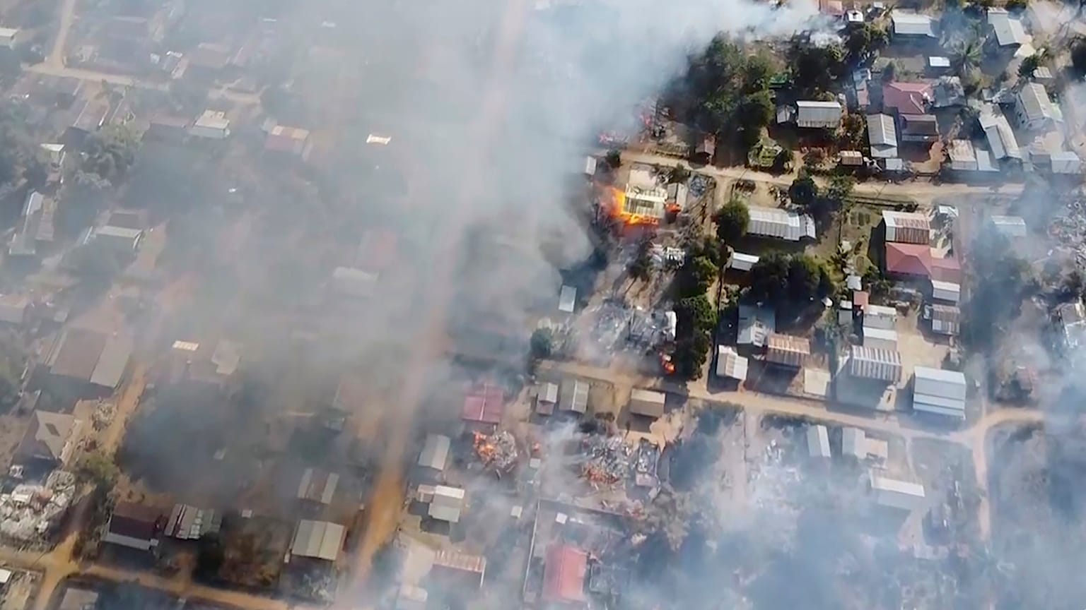 In this image taken from drone video provided by Free Burma Rangers, smoke arises from burning buildings in Waraisuplia village in Kayah State, Myanmar on Feb. 18, 2022.