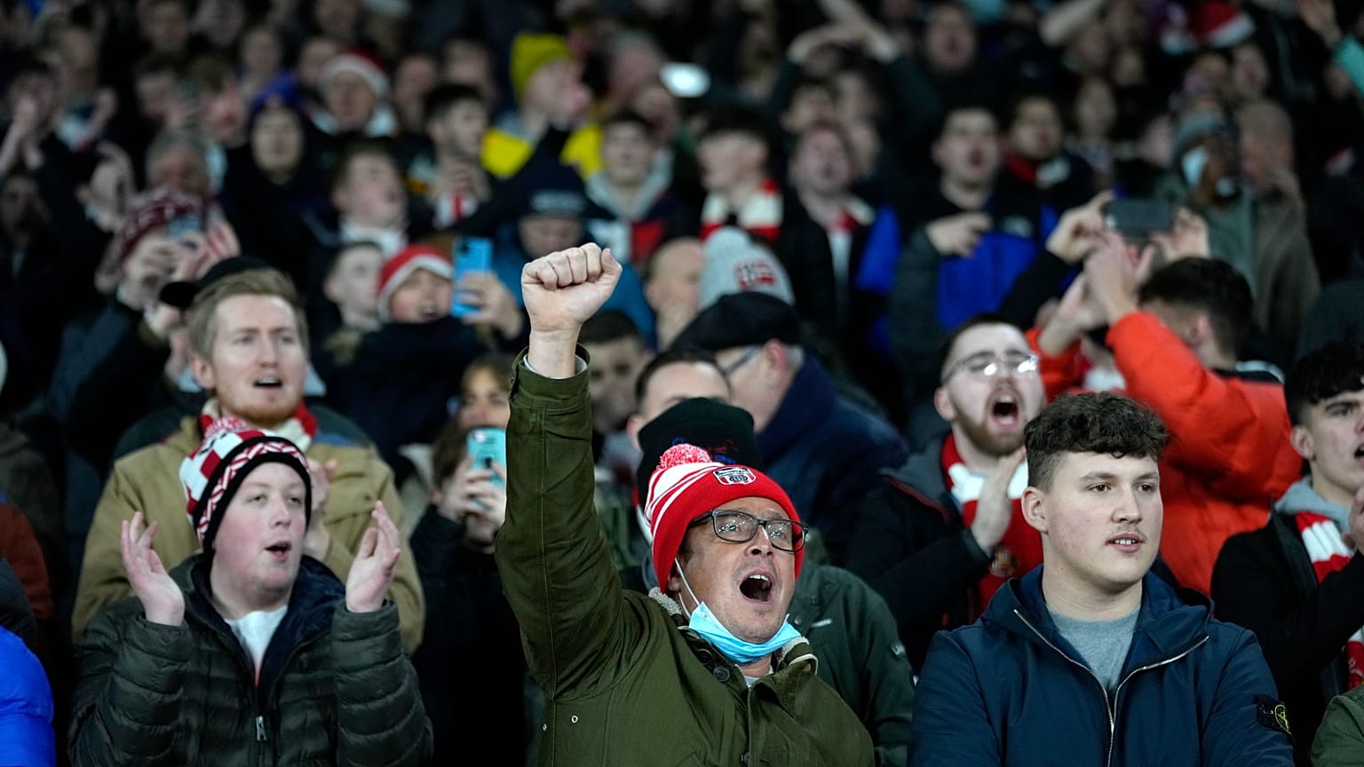 Sunderland fans cheer during the English League Cup quarterfinal match between Arsenal and Sunderland at Emirates stadium in London, Tuesday, Dec. 21, 2021