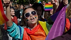 LGBT rights groups and supporters of the community hold banners during the country's first Gay Pride parade on Tuesday Oct. 10, 2017, in Kosovo's capital Pristina. 