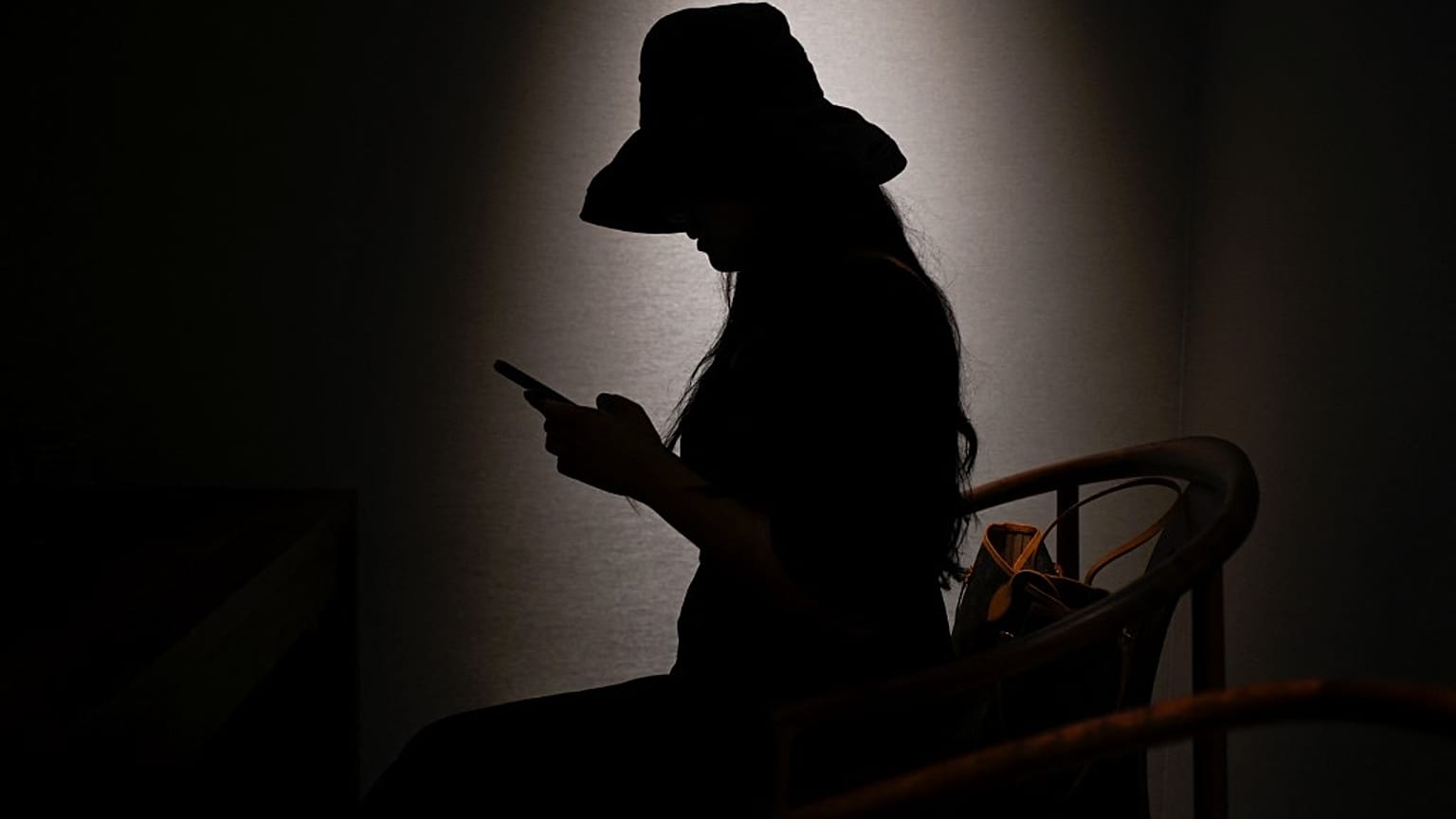 This picture taken on July 16, 2021 shows Melissa using her mobile phone to message her virtual boyfriend - a chatbot created by XiaoIce, a cutting-edge artificial intelligenc