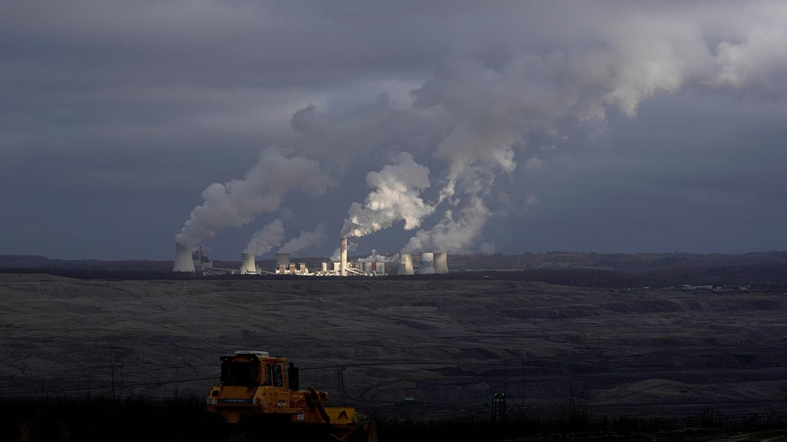 Smoke rises from chimneys of Turow power plant located by the Turow lignite coal mine near the town of Bogatynia, Poland.