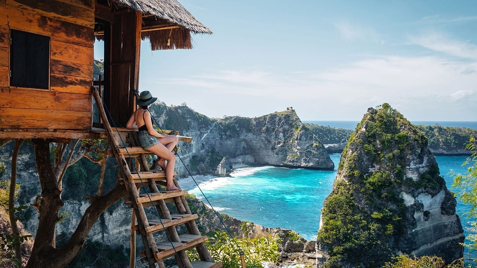 A traveller in a treehouse on Nusa Penida Island, Bali.