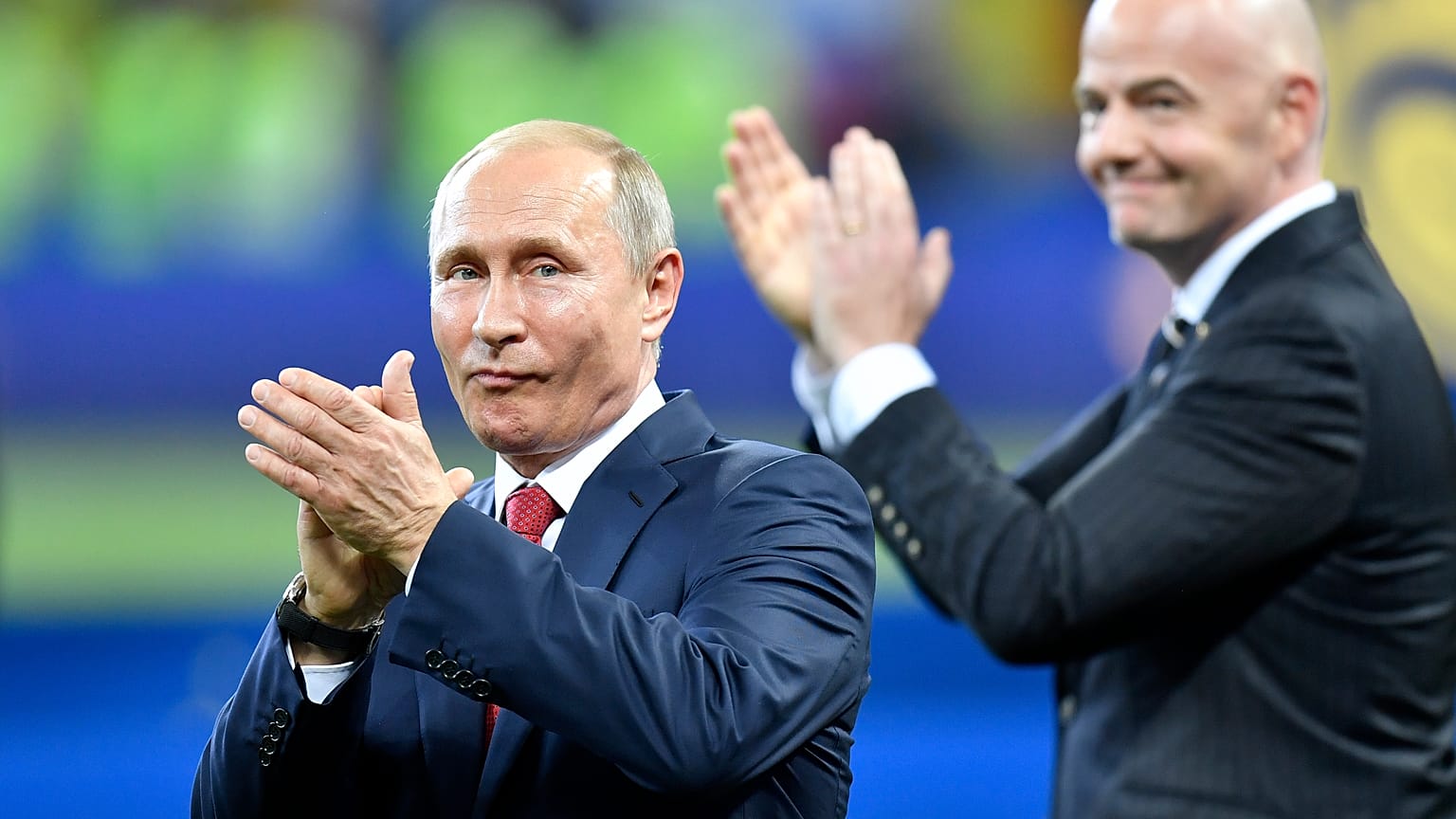 Vladimir Putin, left, applauds besides FIFA President Gianni Infantino