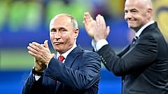 Vladimir Putin, left, applauds besides FIFA President Gianni Infantino