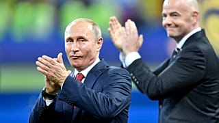Vladimir Putin, left, applauds besides FIFA President Gianni Infantino
