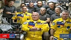Russian cosmonauts Sergey Korsakov, Oleg Artemyev and Denis Matveev are seen during a welcome ceremony after arriving at the International Space Station, Friday, March 18.
