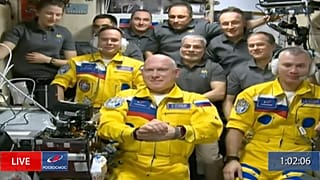 Russian cosmonauts Sergey Korsakov, Oleg Artemyev and Denis Matveev are seen during a welcome ceremony after arriving at the International Space Station, Friday, March 18.