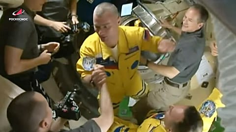 Newly-arrived to the ISS, Russian cosmonauts Denis Мatveev, centre, and Sergei Korsakov, right, bottom say hello to other participants of expedition.