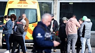 The scene near a gymnasium where witnesses and relatives of victims are received after a car crashed into a crowd of carnival-goers in La Louvière, March 20, 2022.