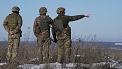 Ukrainian servicemen survey the impact areas from shells that landed close during the night on a front line outside Popasna, Luhansk region, Feb. 14, 2022.