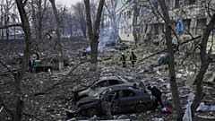 Ukrainian emergency employees work at a maternity hospital damaged by shelling in Mariupol.