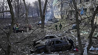 Ukrainian emergency employees work at a maternity hospital damaged by shelling in Mariupol.