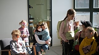 Refugee children from Ukraine wait with their mothers for the start of their classes in Berlin, Germany, March 21, 2022. 