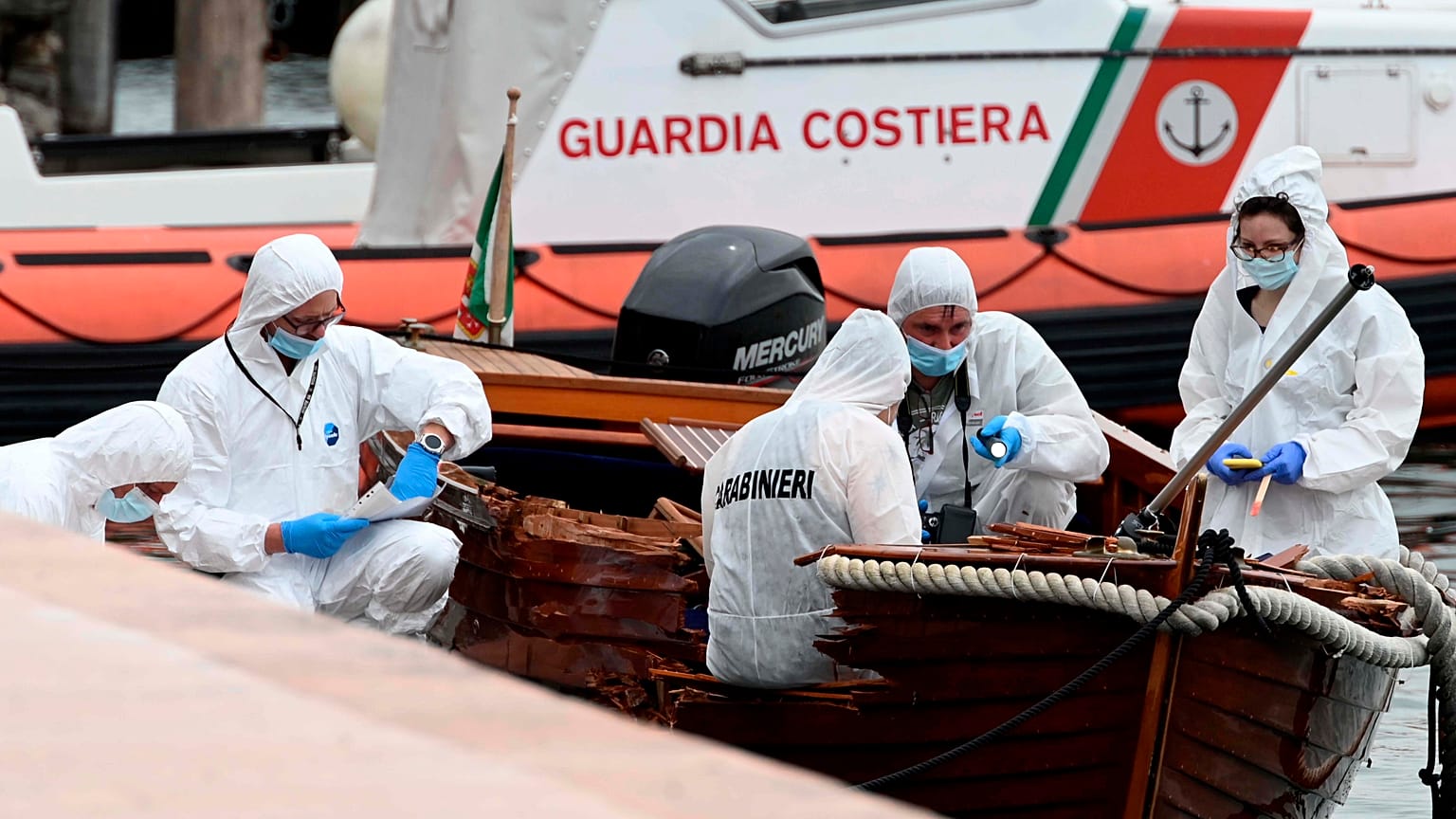 Italian forensic police inspect the damage on the boat in Salo on Lake Garda.