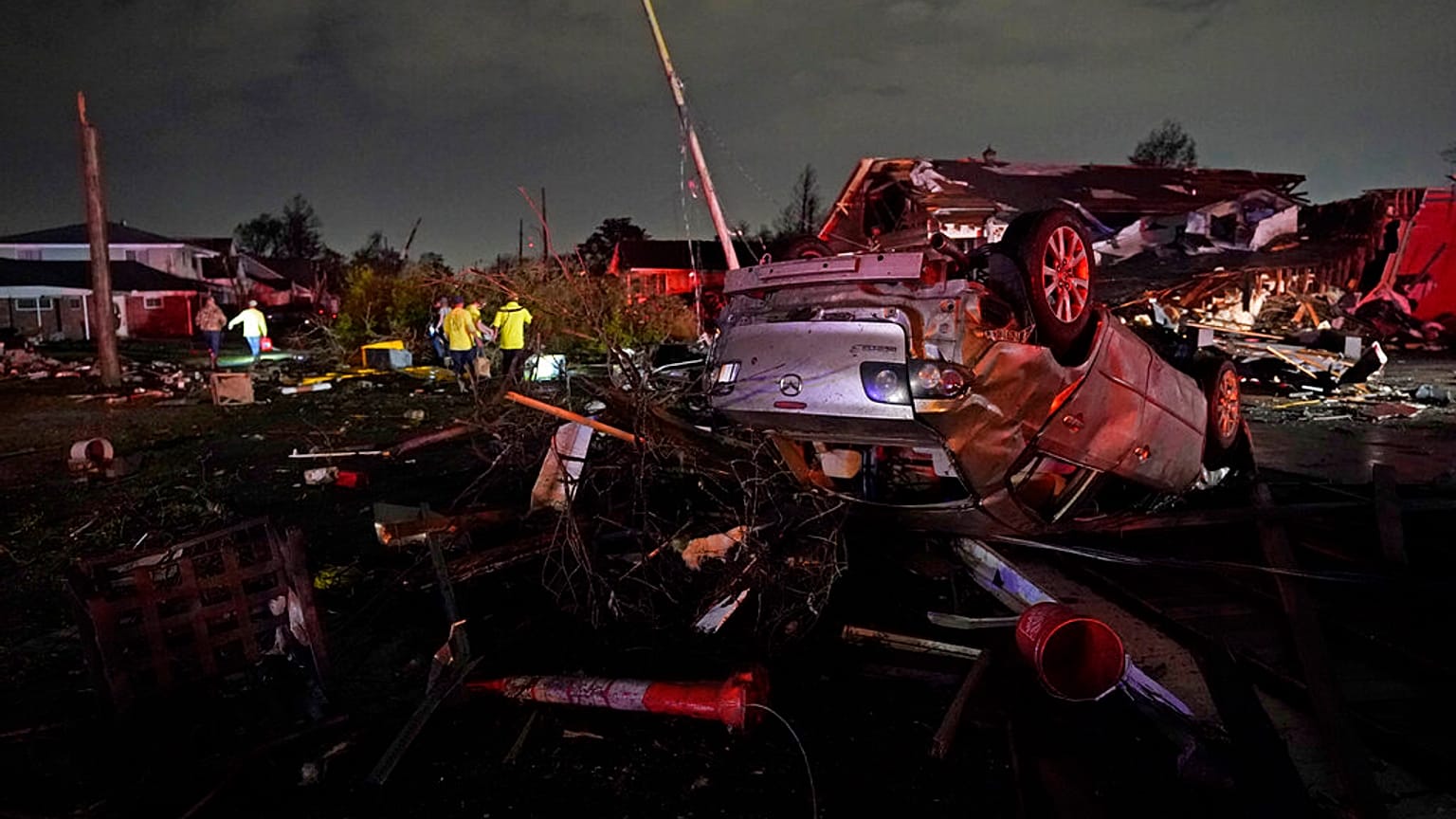 A car is flipped over after a tornado tore through the area in Arabi, La., March 22, 2022