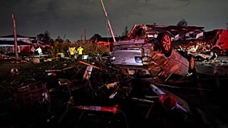 A car is flipped over after a tornado tore through the area in Arabi, La., March 22, 2022