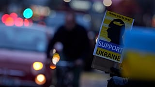 Demonstrators hold placards as they protest about the Russian invasion of Ukraine.