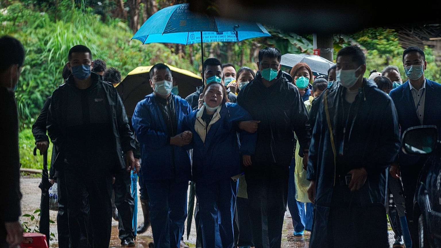 A relative of passengers onboard the China Eastern Flight 5735 cries as she is escorted near the crash site, Thursday, March 24, 2022.