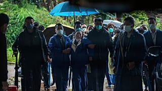 A relative of passengers onboard the China Eastern Flight 5735 cries as she is escorted near the crash site, Thursday, March 24, 2022.