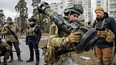 A Ukrainian Territorial Defence Forces member holds an NLAW anti-tank weapon, in the outskirts of Kyiv, Ukraine