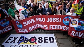 People take part in a union protest in solidarity with 800 P&O Ferries workers fired last week, opposite the Houses of Parliament, in London, Monday, March 21, 2022.