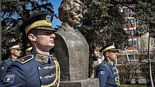 Kosovo Army honor guards stand guard next to a statue of former U.S. Secretary of State Madeleine Albright, in Pristina, Kosovo, Thursday, March 24, 2022. 