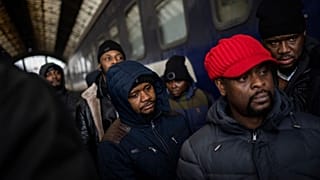 African residents in Ukraine wait at the platform inside Lviv railway station, Sunday, Feb. 27, 2022, in Lviv, west Ukraine.