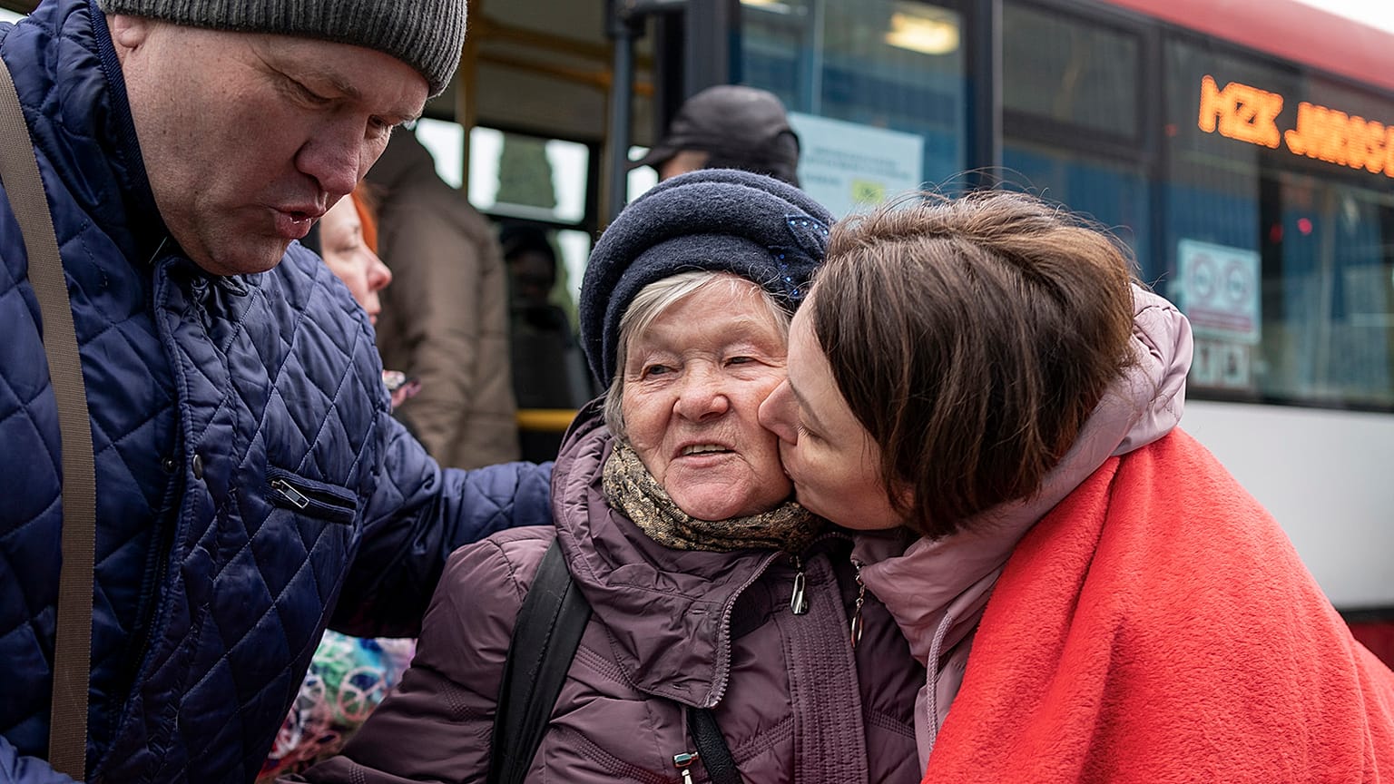 An elderly Ukrainian woman is welcomed in Korczowa on the Polish-Ukrainian border