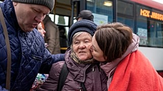 An elderly Ukrainian woman is welcomed in Korczowa on the Polish-Ukrainian border