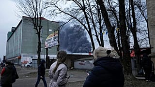 Einwohner von Lviv in der Westukraine, im Hintergrund Rauch, am 26.03.2022 