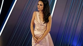 Mila Kunis introduces a performance by Reba McEntire at the Oscars on Sunday, March 27, 2022, at the Dolby Theatre in Los Angeles.