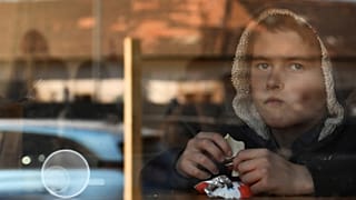 A young boy from Ukraine eats chocolate in a hostel in Budapest, Hungary, Thursday, March 24, 2022.