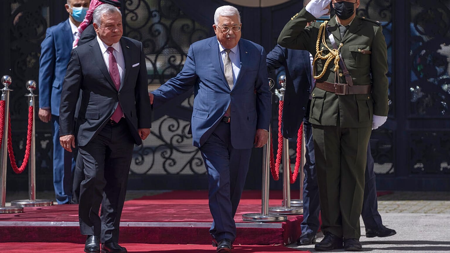 Palestinian President Mahmoud Abbas, right receives Jordan's King Abdullah II,