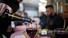 Französischer Genuss: Ein Kunde schenkt ein Glas Beaujolais Nouveau in einem Restaurant in Boulogne Billancourt, außerhalb von Paris, ein