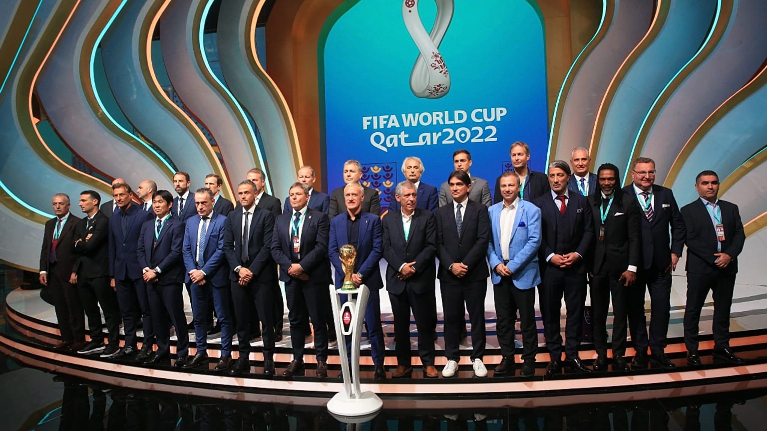 Coaches pose for a group photo following the 2022 soccer World Cup draw at the Doha Exhibition and Convention Center in Doha, Qatar, Friday, April 1, 2022. 