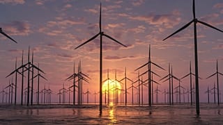 Wind farm appearing over the horizon.