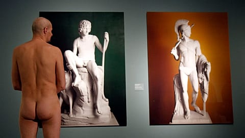 A naked museum visitor at the show "Nude Men from 1800 to Today" during a special opening to friends of nudism at the Leopold Museum, Vienna in 2013