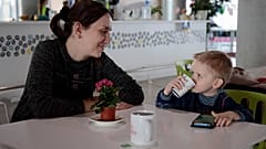 Elena Litvinova, 33, an accountant from Mykolaiv, smiles at her 3 year-old son, Artem, after an interview with AP at a refugee center in Brasov, Romania, March 30, 2022.