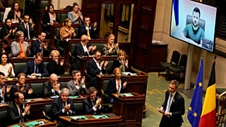 Belgium's Prime Minister Alexander De Croo walks off the podium as Ukraine's President Volodymyr Zelenskyy addresses Belgian MPs in Brussels, Thursday March 31 2022.