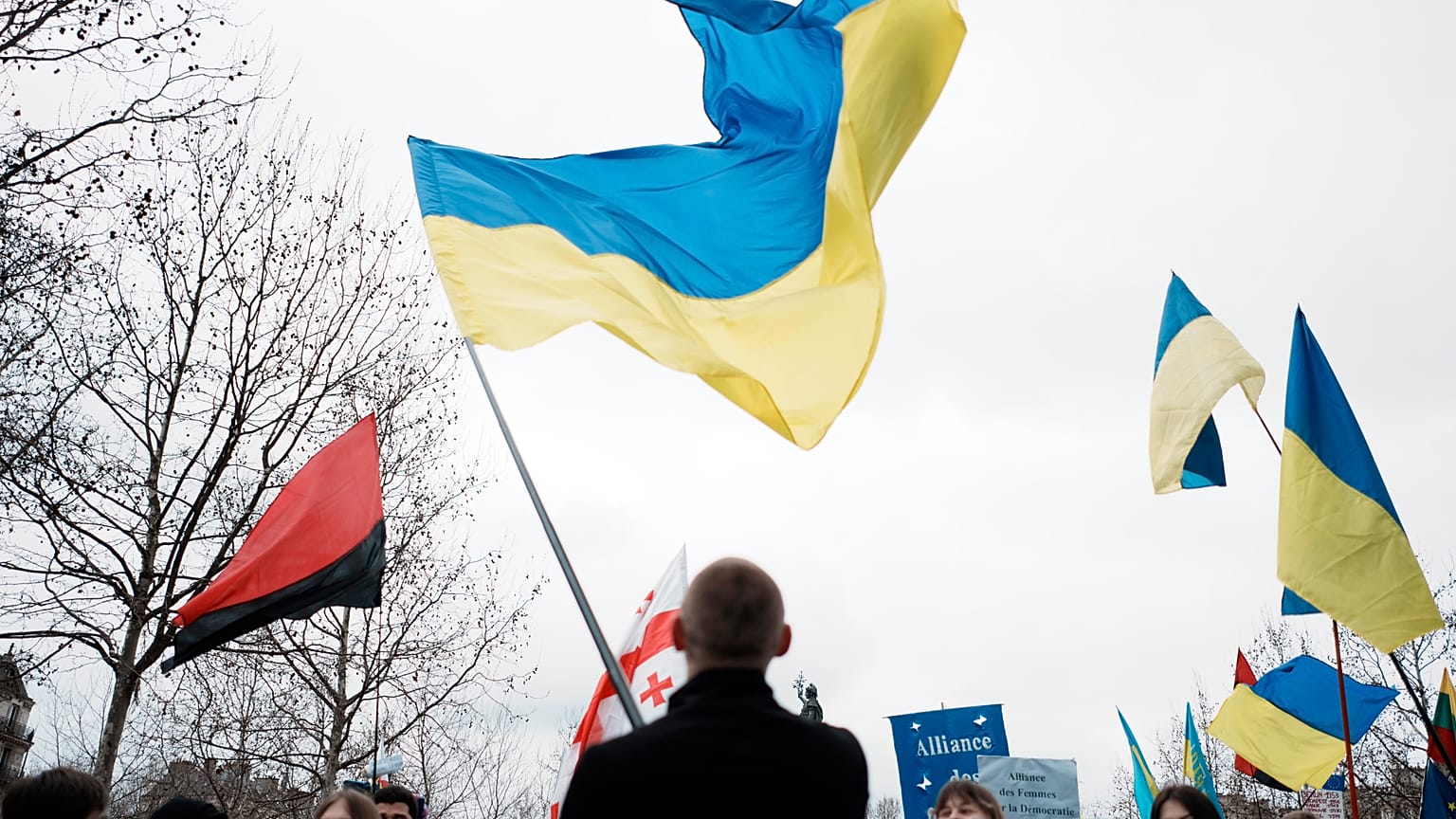 A man waves a Ukrainian flag at a Paris demonstration against the Russian invasion.