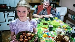 Ethnic Hungarian girl Jacinta Kosza shows Easter eggs after they were painted with boiled onion-skin in her home in Ineu, Transylvania, Romania, Saturday, April 19, 2019.