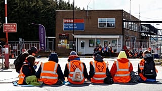 Just Stop Oil activists take part in a protest outside the Esso Birmingham fuel terminal, in Birmingham, Britain April 1, 2022.