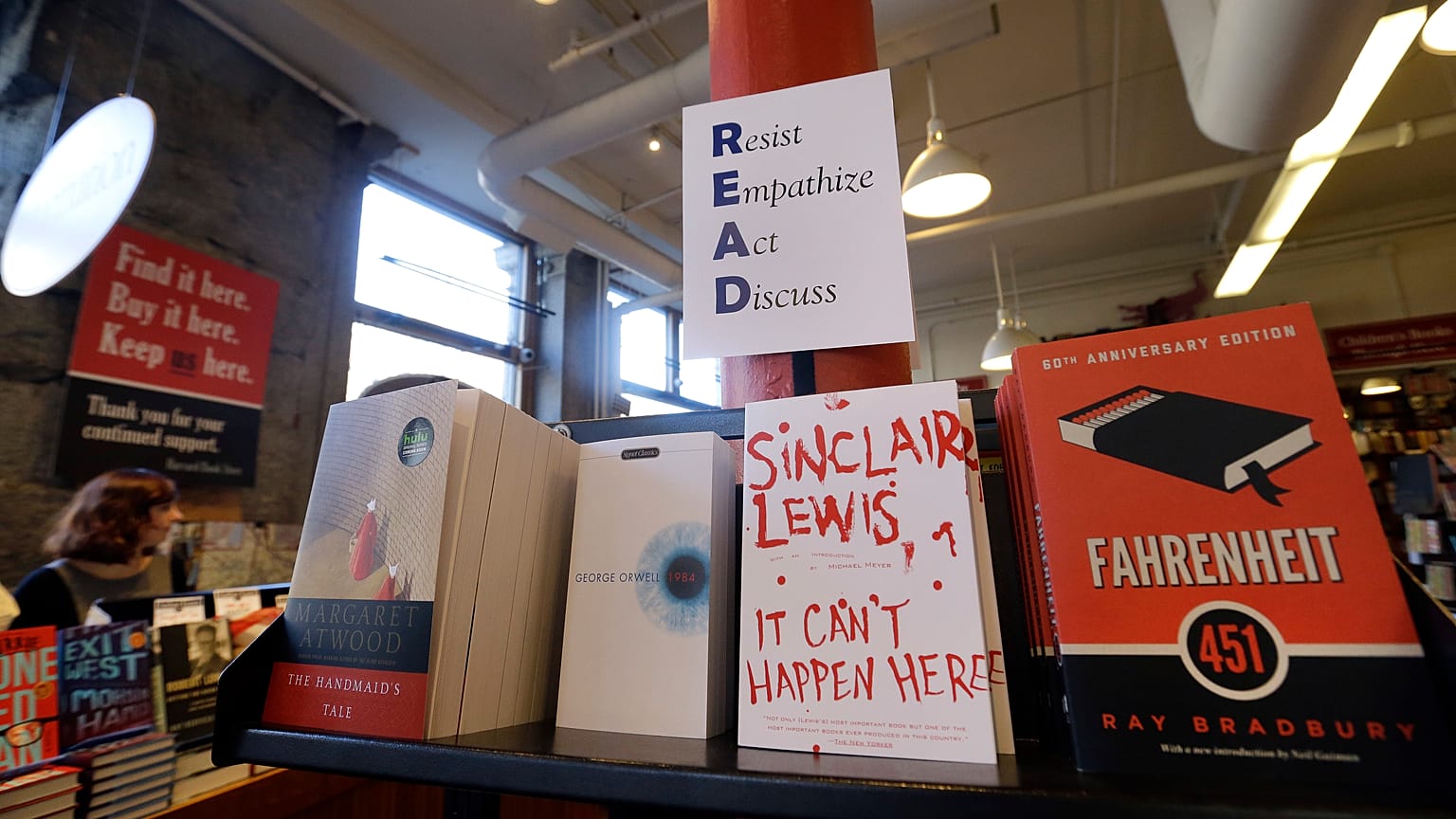 Books are displayed under a sign at the Harvard Book Store