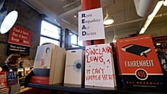 Books are displayed under a sign at the Harvard Book Store
