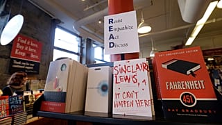 Books are displayed under a sign at the Harvard Book Store