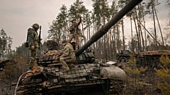 Ukrainische Soldaten posieren auf einem russischen Panzer im Großraum Kiew, 31.03.2022