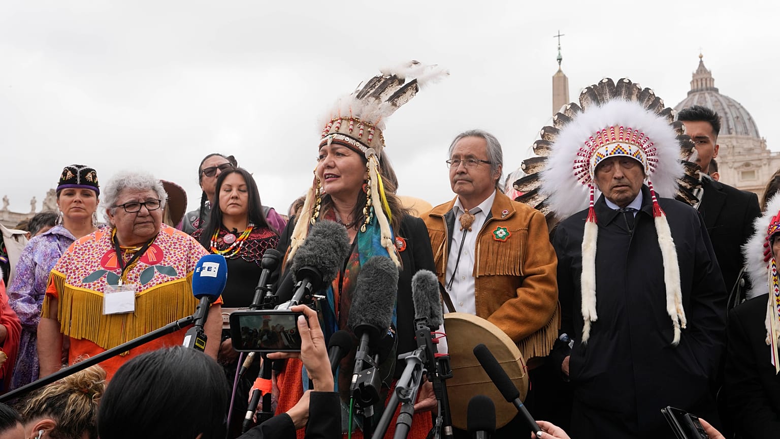 A member of the Assembly of First Nations speaks outside St. Peter's Square at the end of a meeting with Pope Francis at the Vatican
