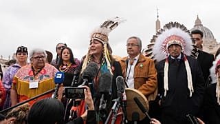 A member of the Assembly of First Nations speaks outside St. Peter's Square at the end of a meeting with Pope Francis at the Vatican